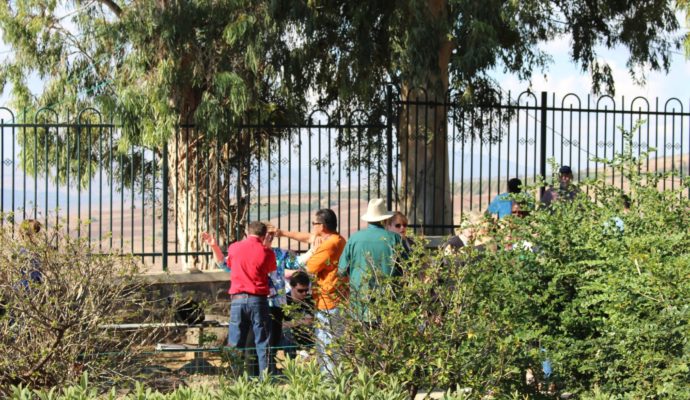 There's power in prayer. These people visiting the Mount of The Beatitudes in Israel laid hands on one another.